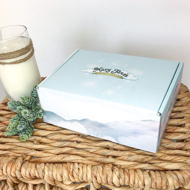 Light blue and cream product box with festive ornament accent
