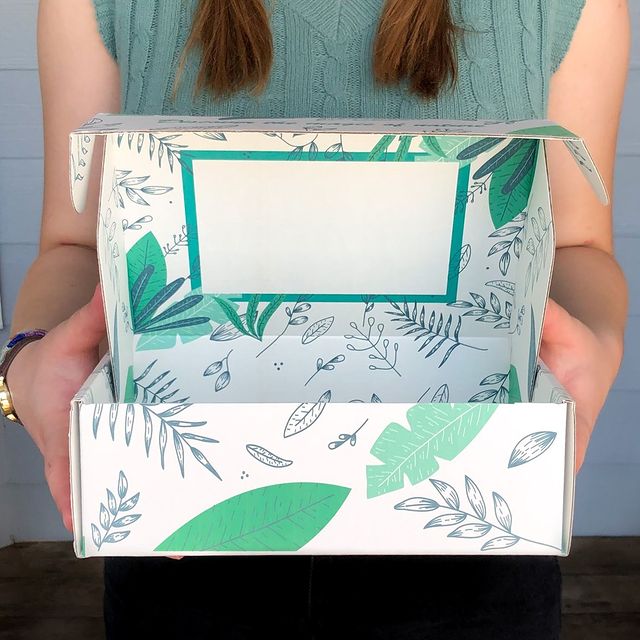 Green and white leaf-themed subscription box