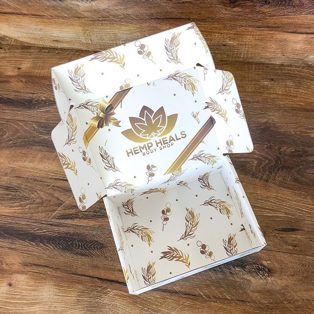 White holiday box with gold snowflakes and tree icons