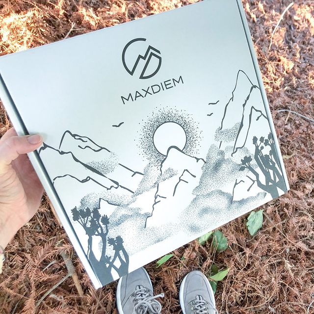 White mailer with mountain landscape and adventure branding