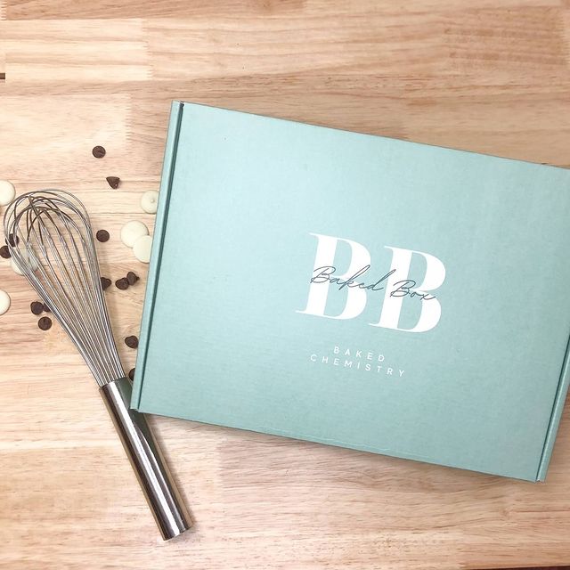 eal green box with metallic 'BB' monogram and pen beside