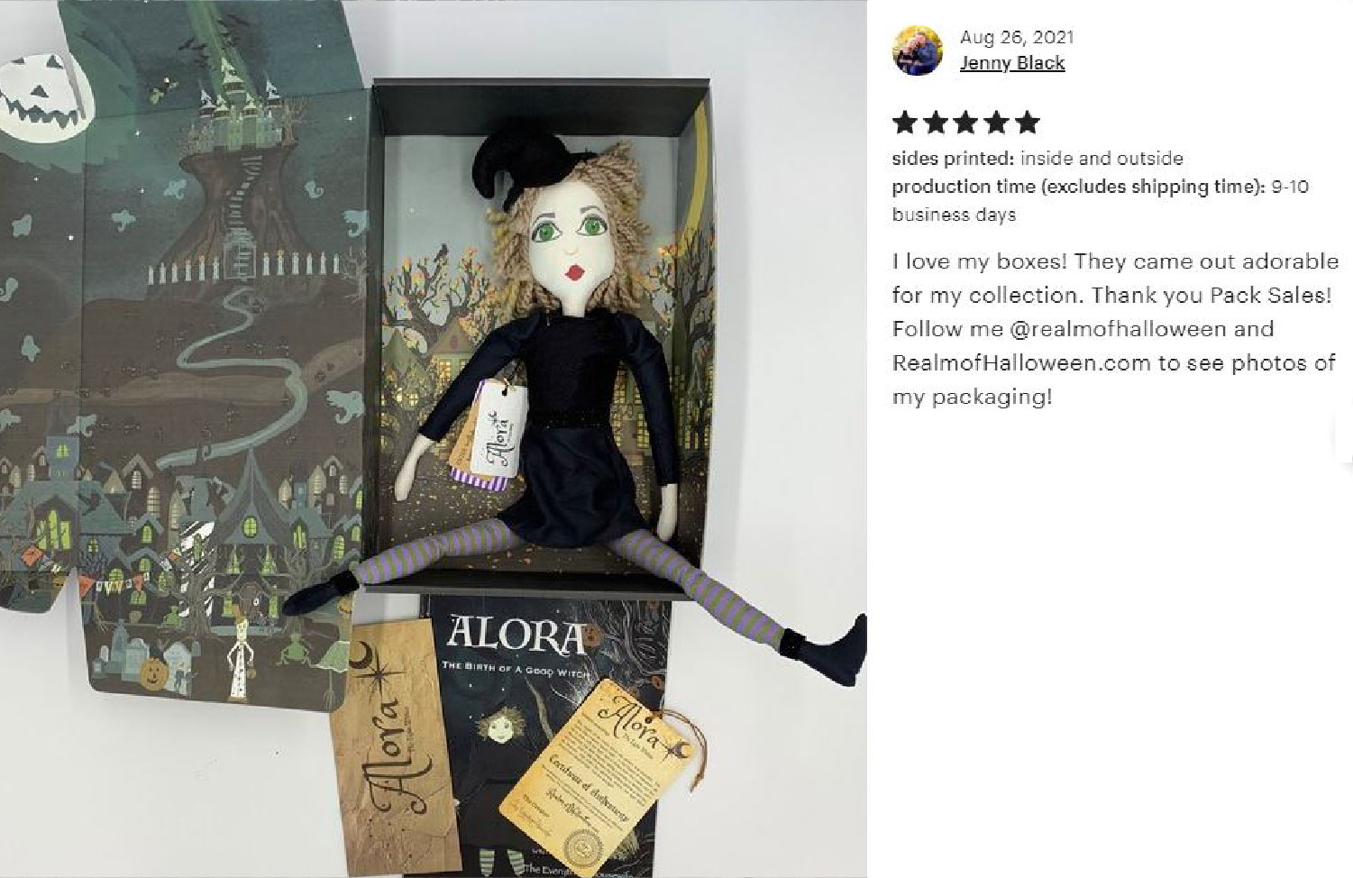 Brown paper box with branded insert next to robed art doll